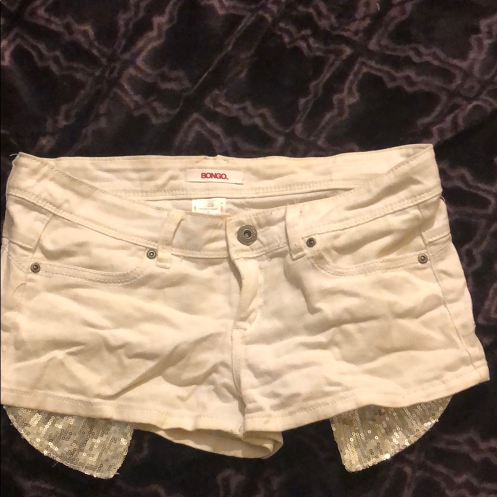 White jean shorts with sparkly silver pockets
